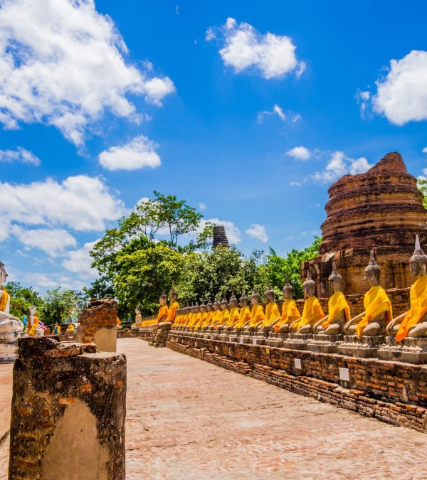 buddha-statues-with-orange-tunics-in-ayutthaya-thailandtravel